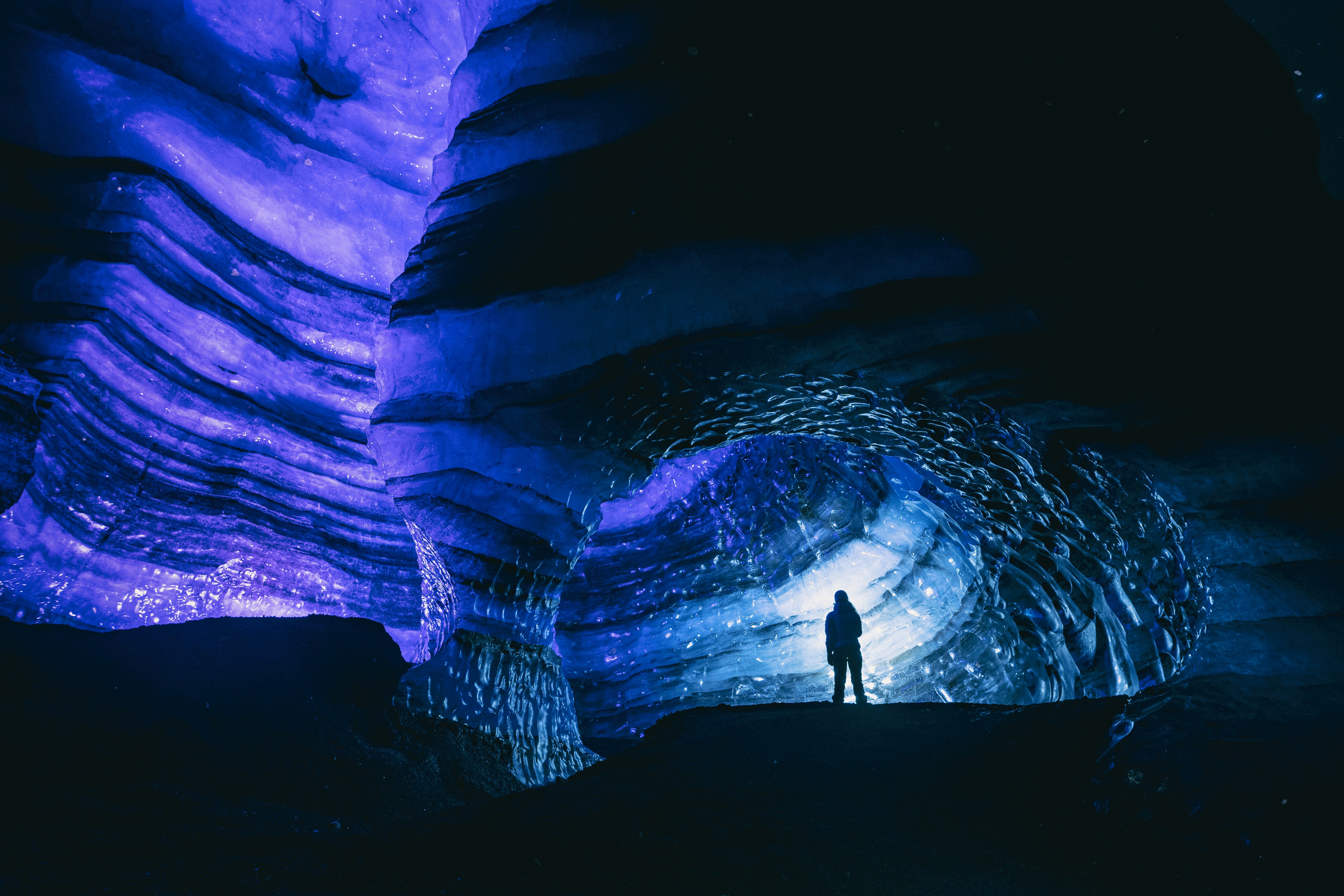 man standing inside cave